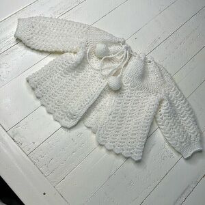Newborn hand, crocheted vintage sweater white girl or boy